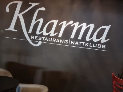 En vägg i "Kharma Restaurang Nattklubb" i Vimmerby med deras logotyp i vit text.